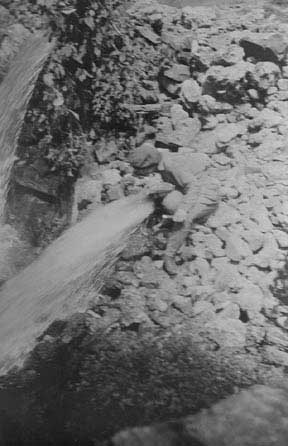 Juanita drinking from a spring feeding the Hahatonka River